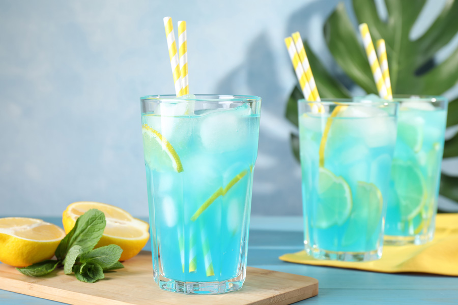 Recipe Les Bleus Lemonade Mood picture: Three drinking glasses are filled with blue lemonade.